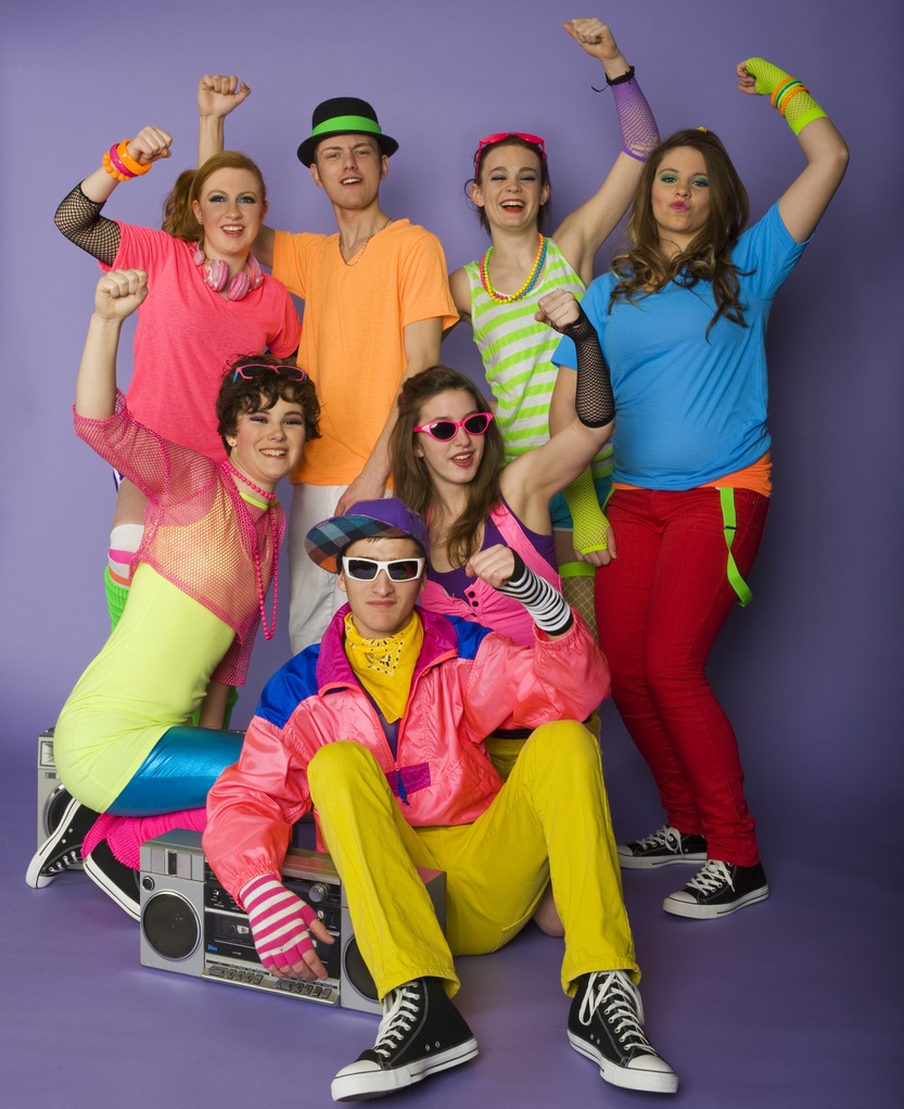 A group of retro styled teen dancers with a boom box